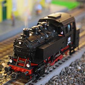 model steam locomotive on tracks with detail features showcasing its design and craftsmanship resembling vintage trains and numbers 9